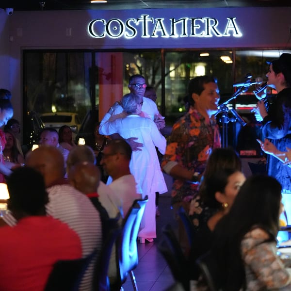 Diners at Costanera Peruvian Cuisine watch a couple dancing and a live band performing.